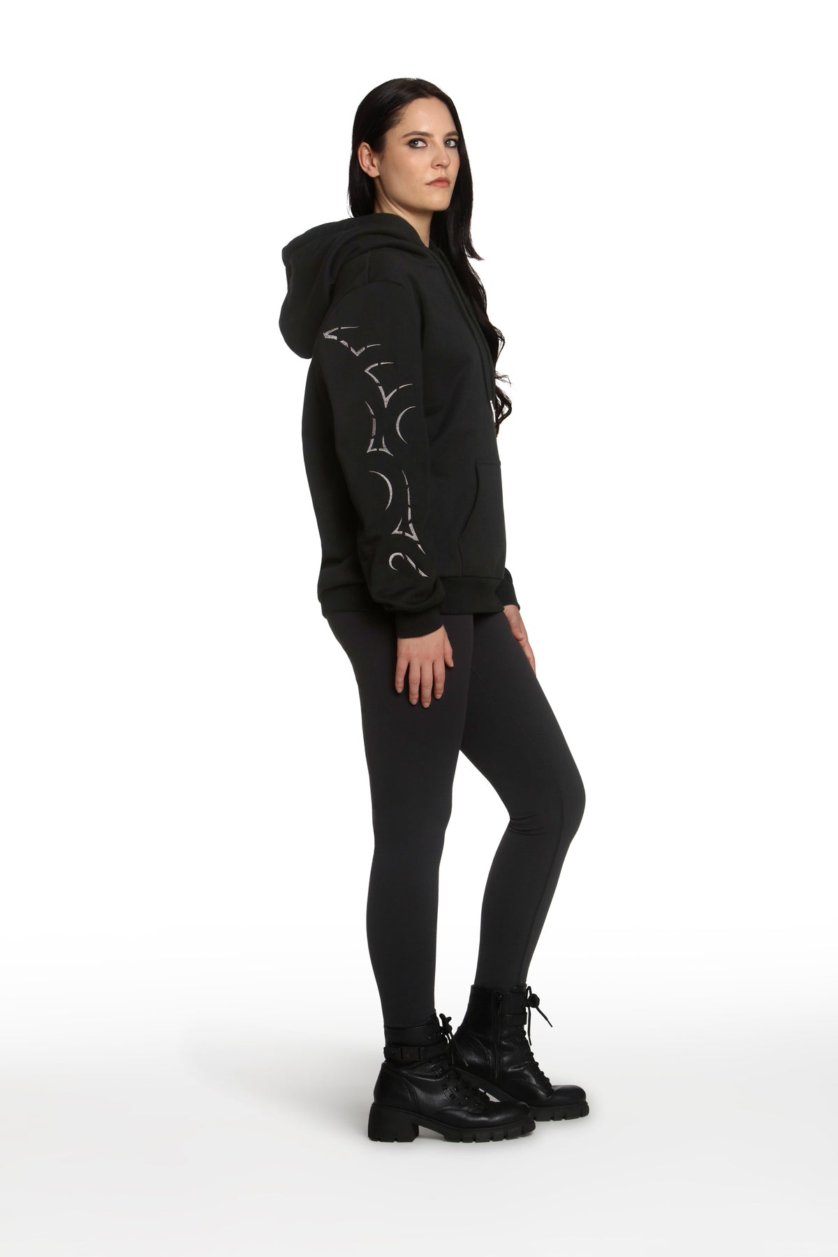 Person wearing a black hoodie with white designs on a white background