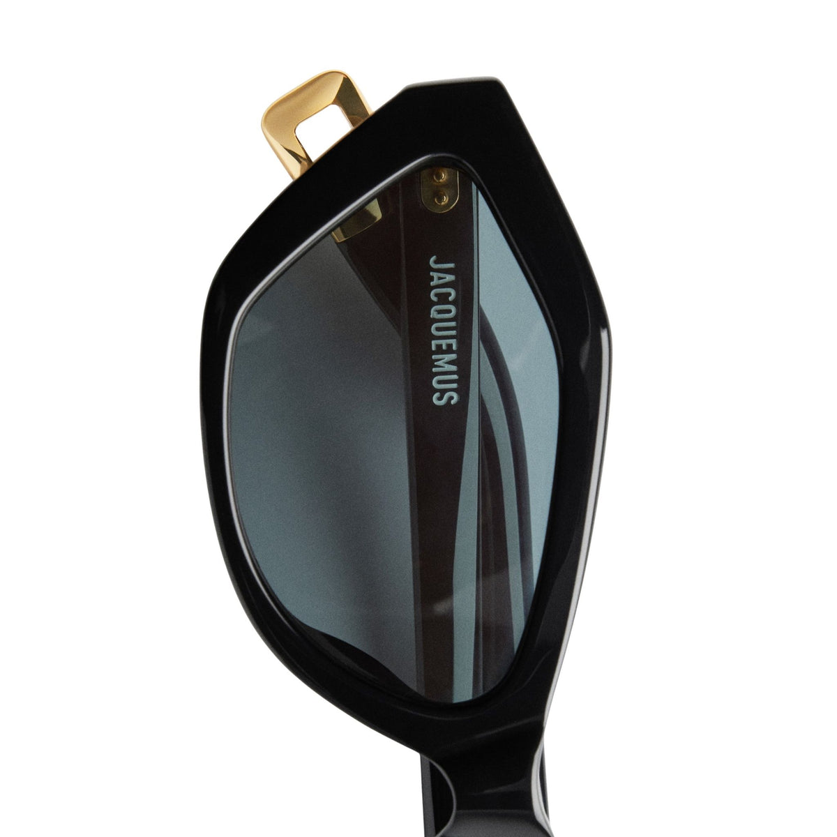 Black sunglasses with gold accents and 'Jacquemus' branding on a white background