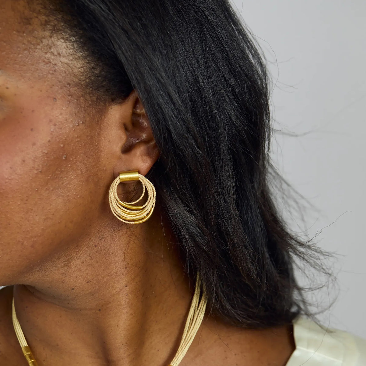 NART multiple buriti earrings close-up on model, buy at DOORS NYC