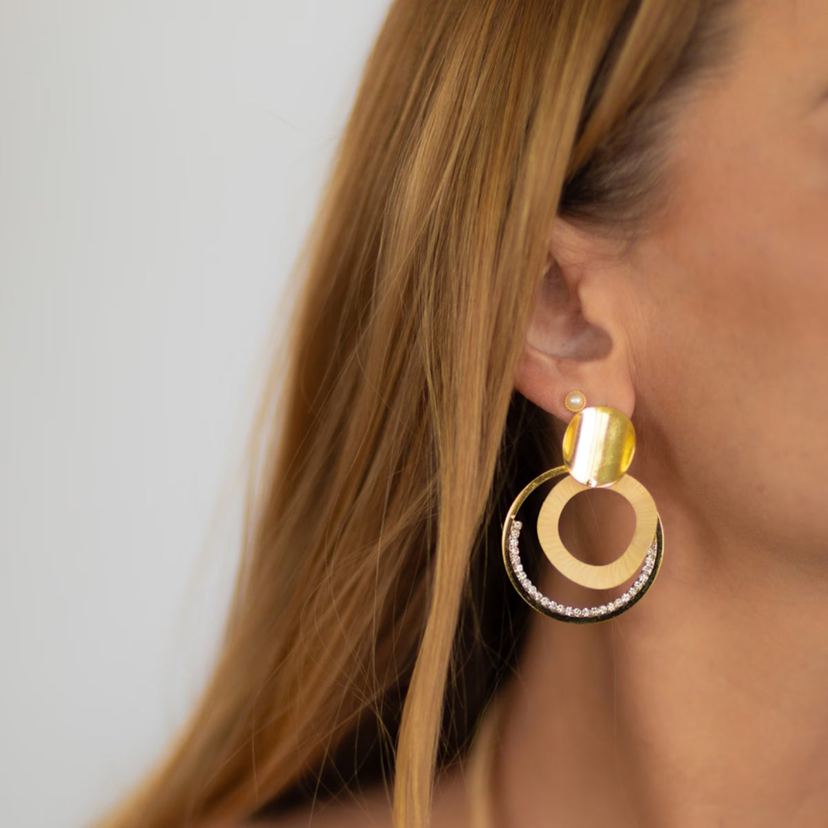 NART shiny arch earrings worn by model, women's artisan earrings, buy at DOORS NYC