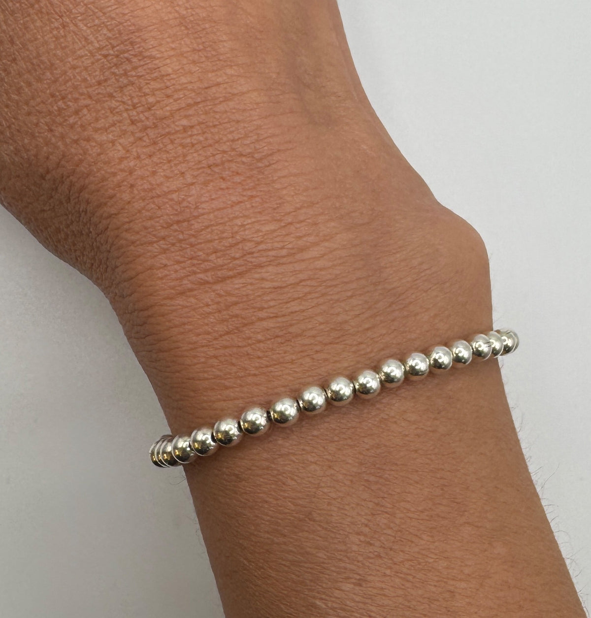 NART silver stackable bracelet 4mm worn by model, stacked silver bracelets, buy at DOORS NYC