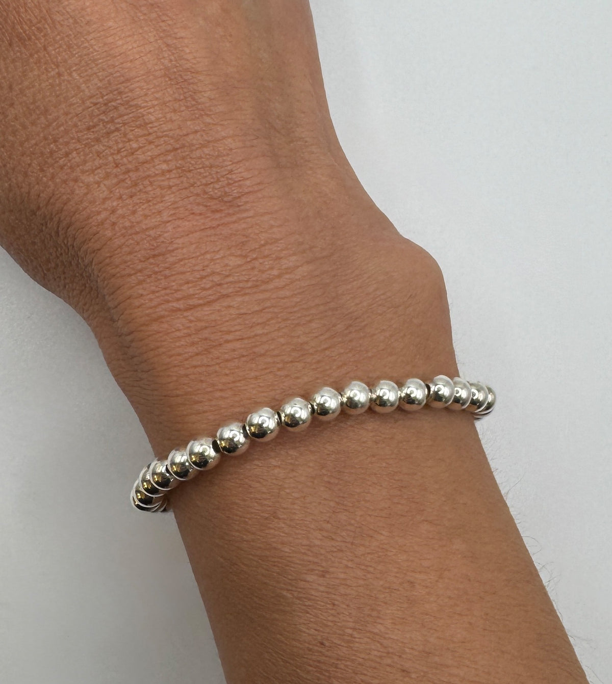 NART silver stackable bracelet 5mm worn by model, stacked silver bracelets, buy at DOORS NYC