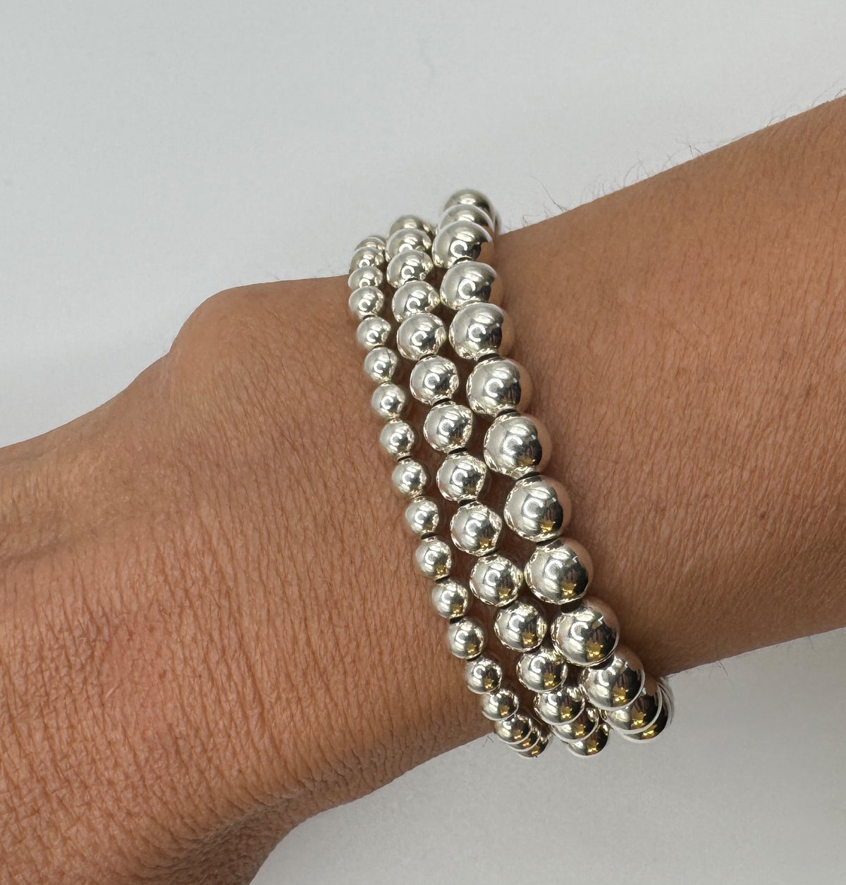 NART silver stackable bracelet 6mm worn by model, stacked silver bracelets, buy at DOORS NYC