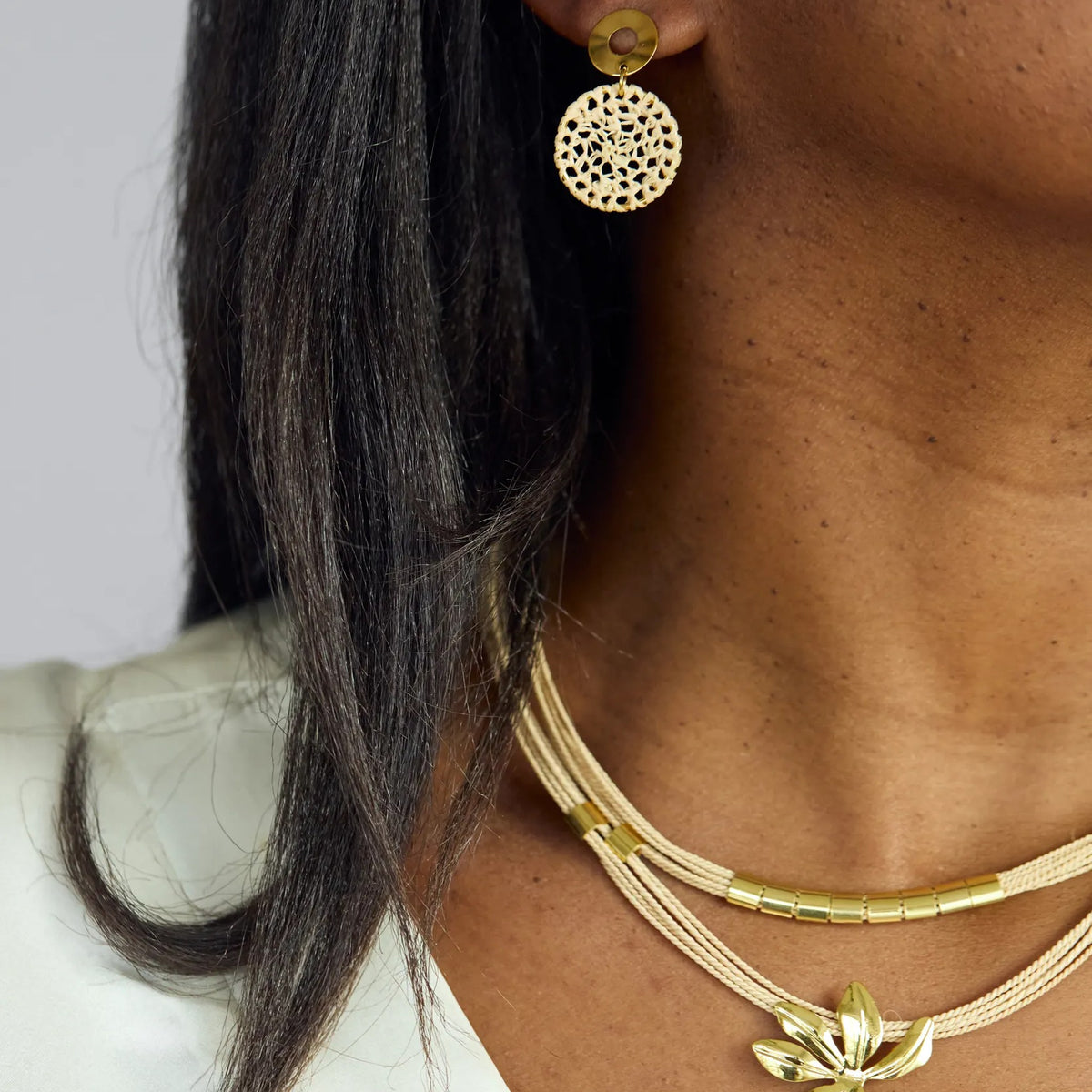 NART small dreamcatcher buriti fiber earrings worn by model, women's artisan earrings, buy at DOORS NYC