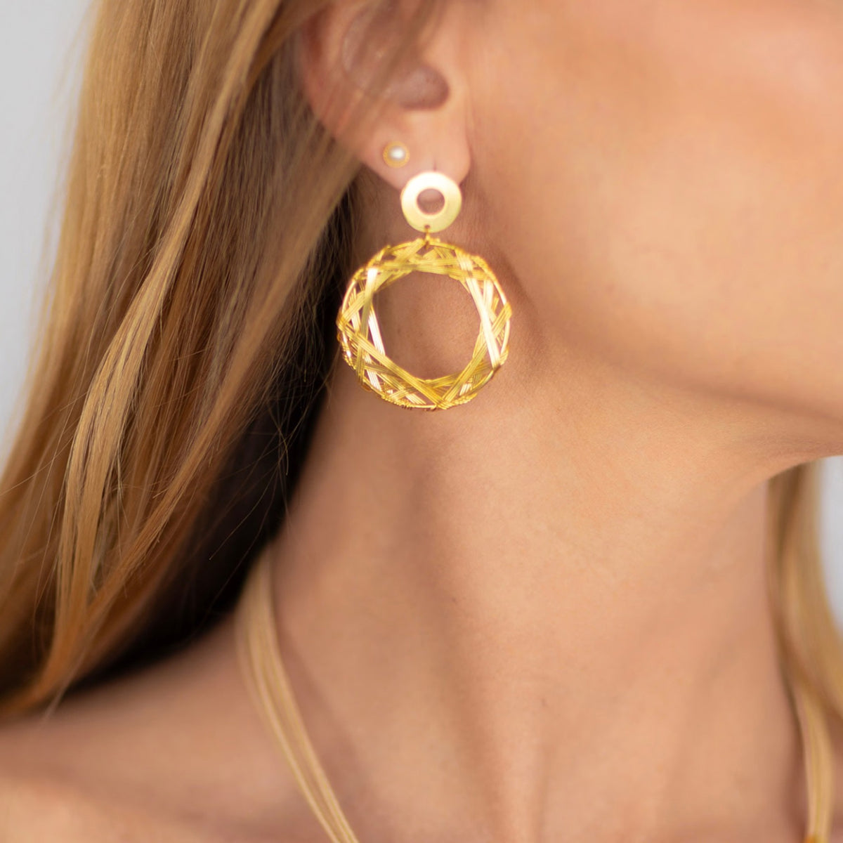NART wheel earrings worn by model, women's artisan earrings, buy at DOORS NYC