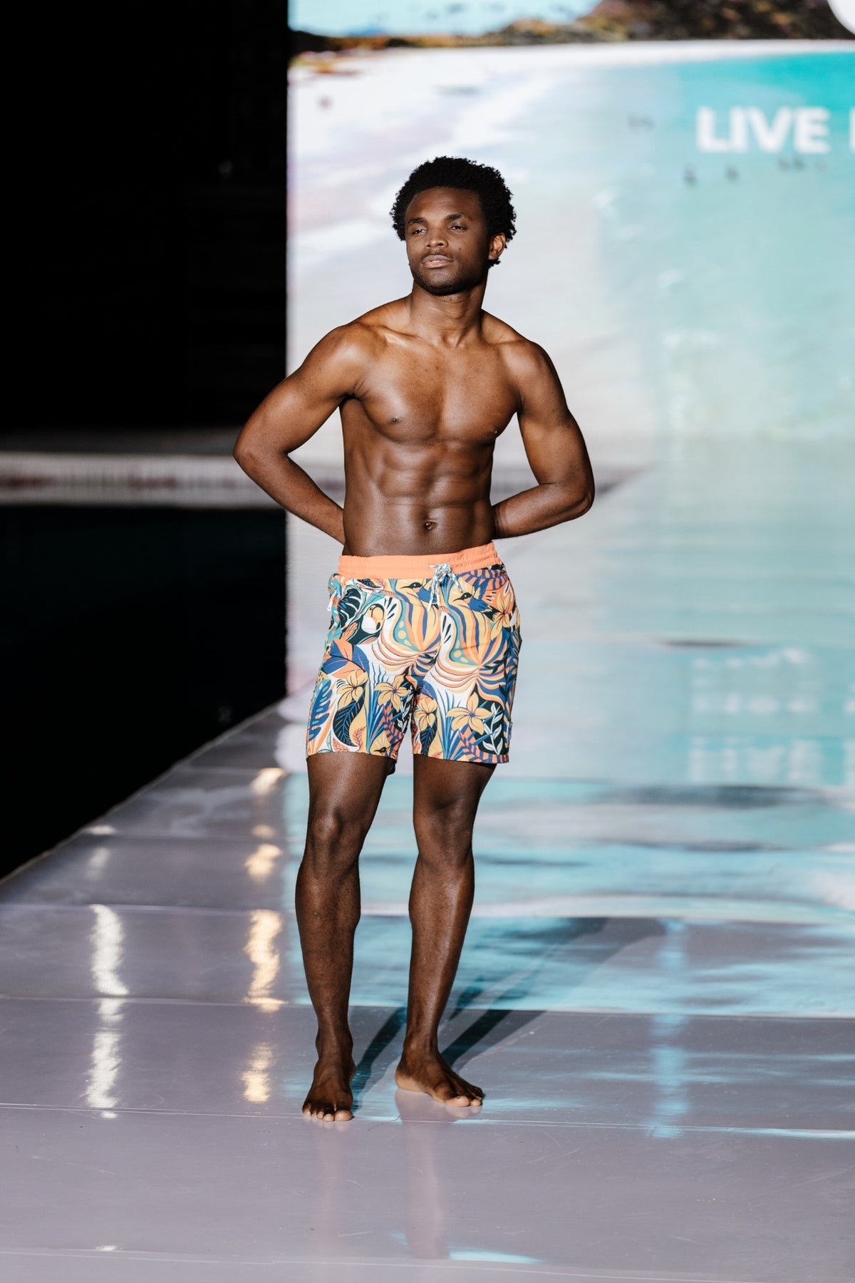 Model wearing eco-friendly jungle print swim shorts