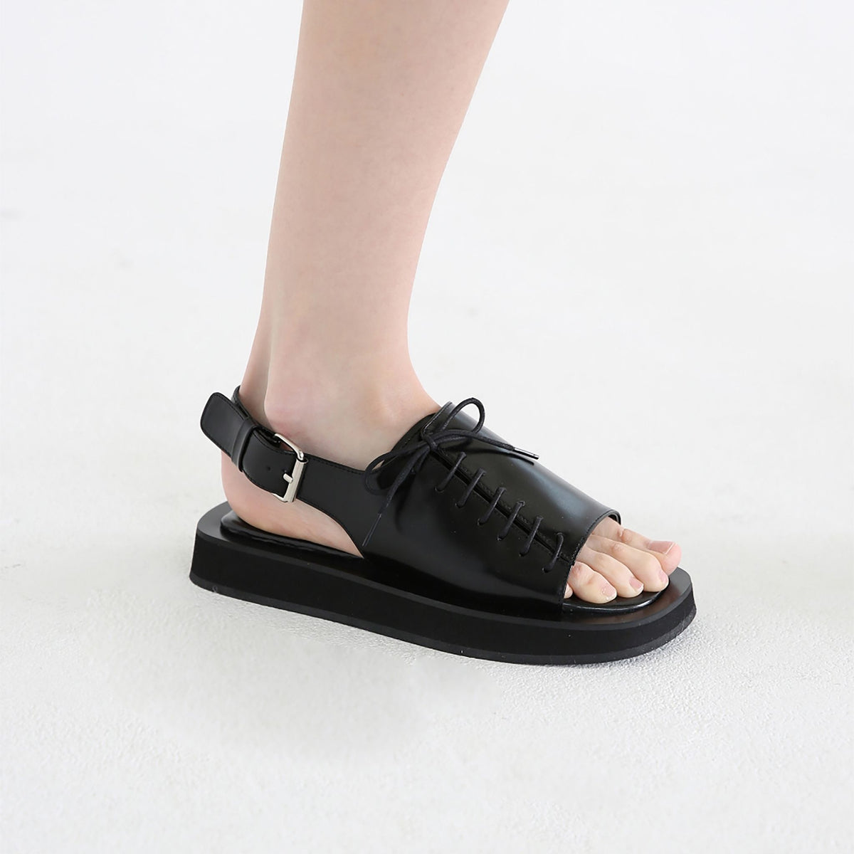 Black Leather Lace‑
Front Slingback Sandals