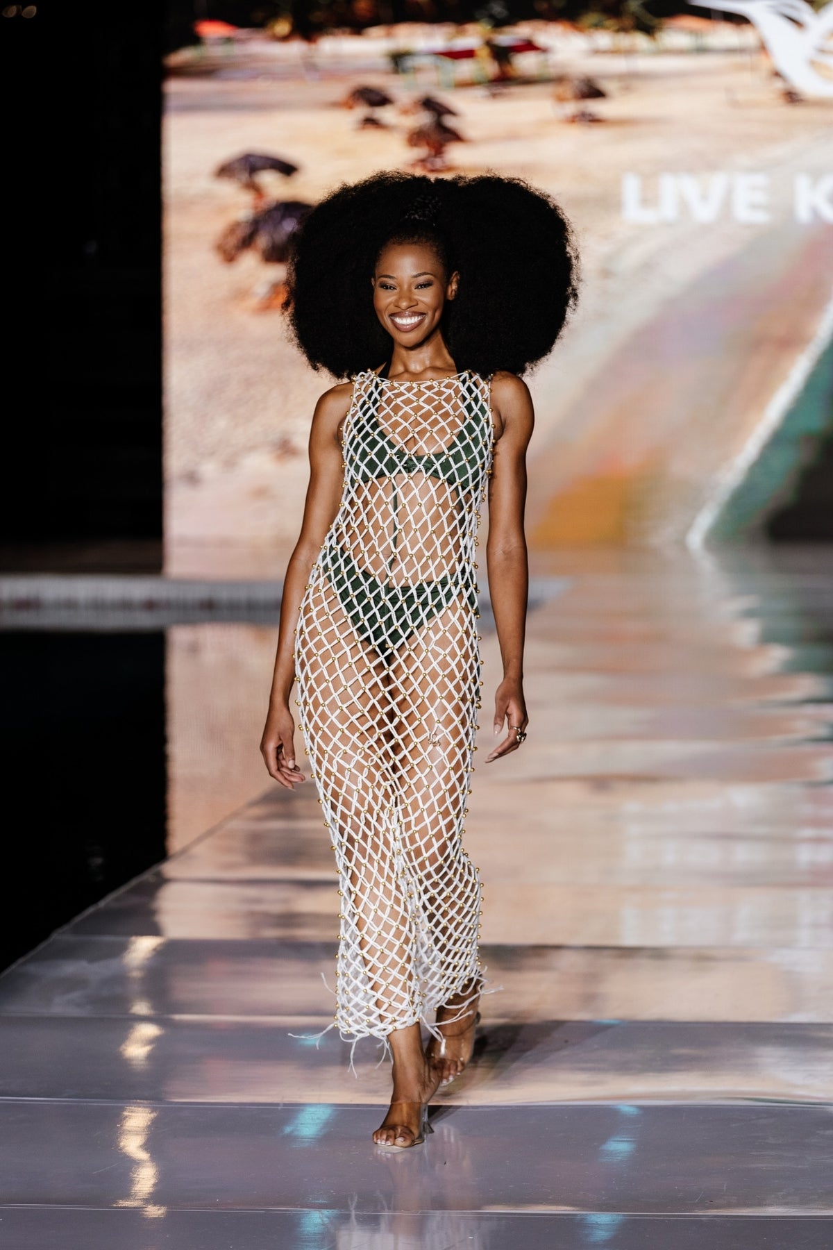 Model wearing cream handwoven crochet dress with gold beads