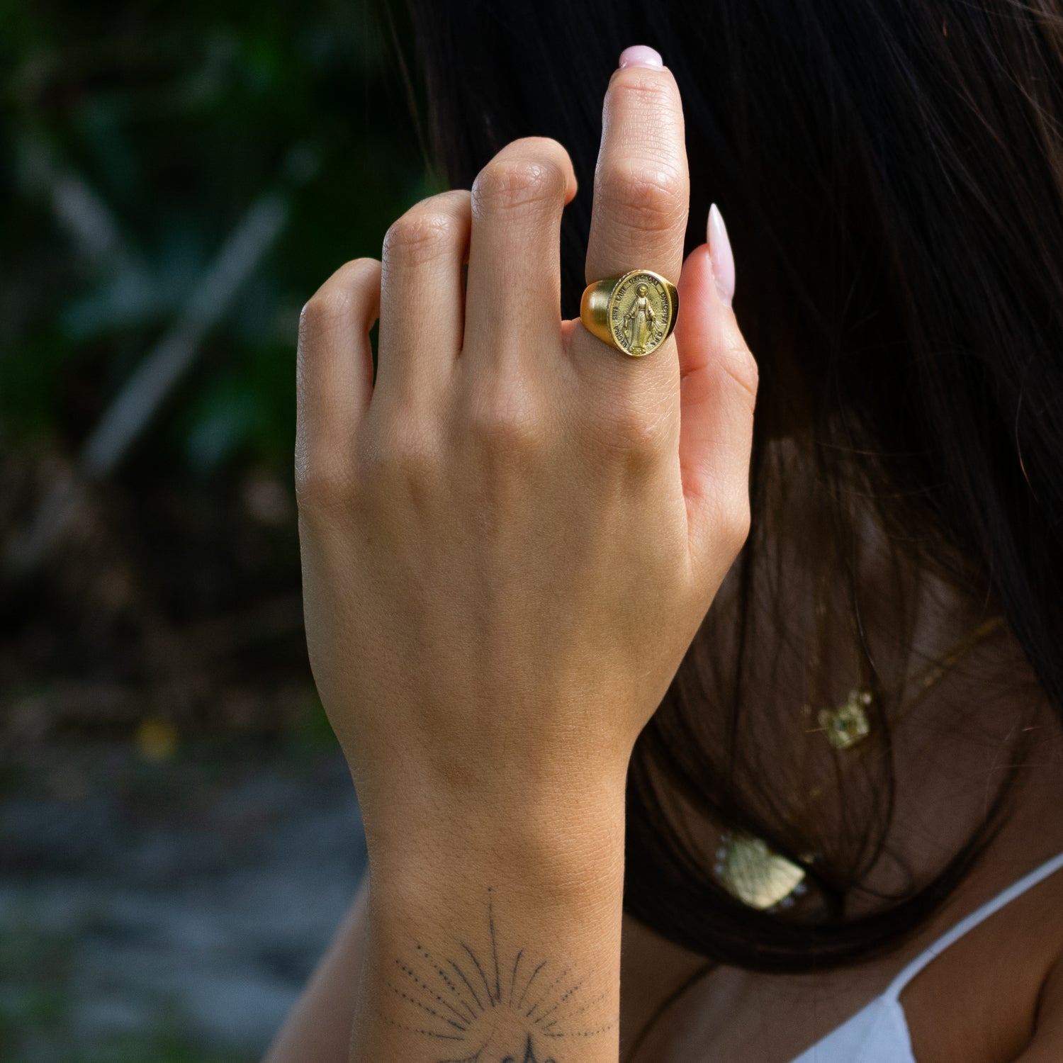 Gold vermeil Virgin Mary ring with raised oval medallion and engraved holy figure detail.