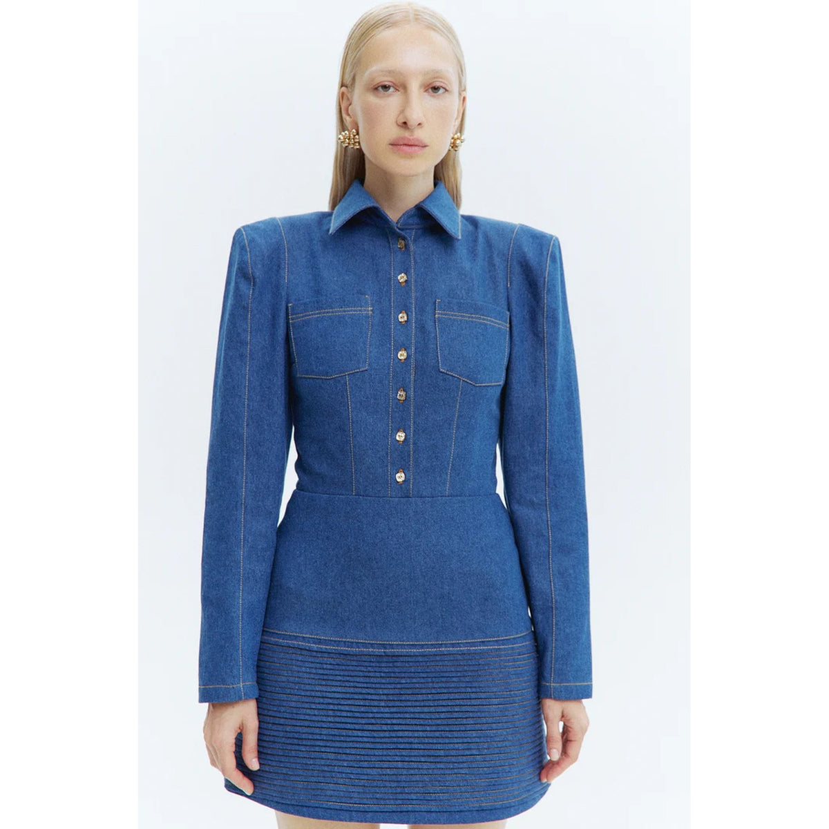 Woman wearing a blue denim dress on a white background