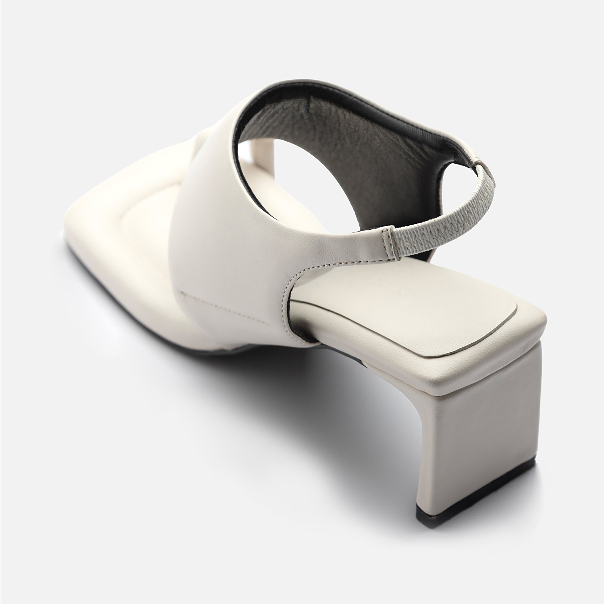 THEN’s White Square-Toe Slingback Heeled Sandals feature off-white leather, a wide upper strap, and an elastic back strap, displayed on a light background.