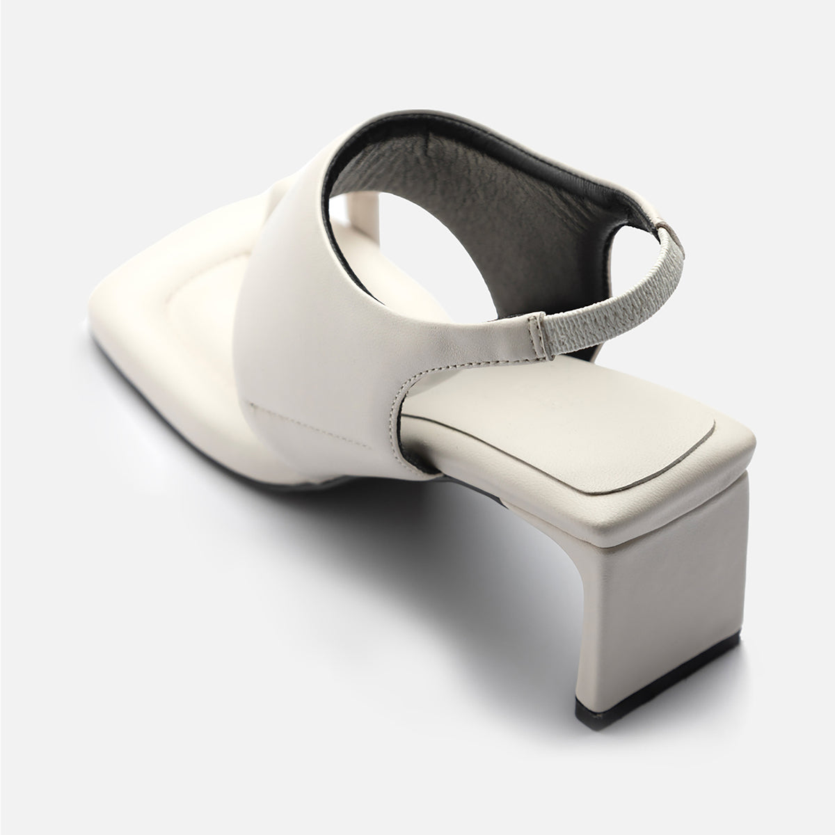 THEN’s White Square-Toe Slingback Heeled Sandals feature off-white leather, a wide upper strap, and an elastic back strap, displayed on a light background.